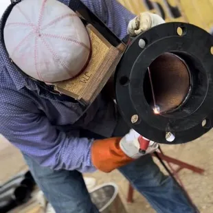 a man welding a baseball