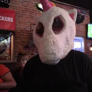 a man wearing a unicorn mask