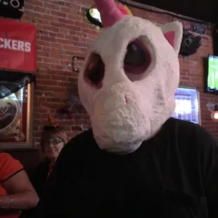 a man wearing a unicorn mask