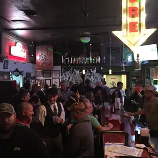 a large group of people sitting at a bar