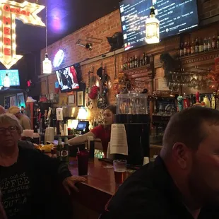 a group of people sitting at a bar