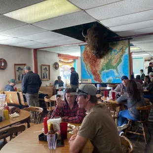 people sitting at tables in a restaurant