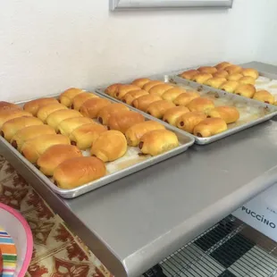 two trays of doughnuts on a table