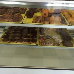 a variety of donuts in a display case