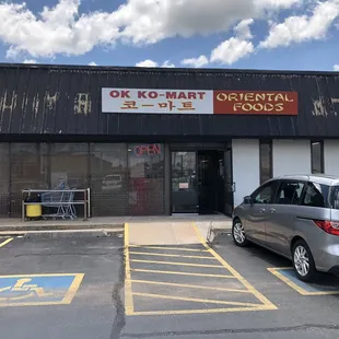 two cars parked in front of the store