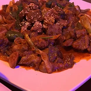 a plate of beef and vegetables