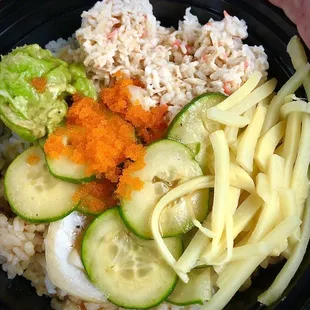 Poke Bowl. White Rice, Imitation Crab, cucumber, onions, bamboo shoots, avocado, fish eggs, and Classic sauce.