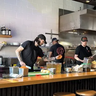 Chefs prepping in the open kitchen.