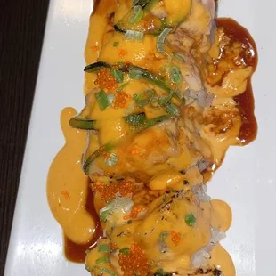 Tons of spicy mayo to cover up raw salmon that is going bad. Look at its pale color.