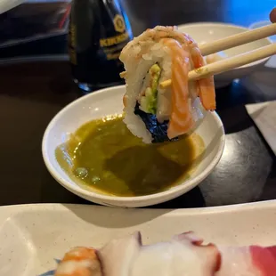 a sushi being lifted by chopsticks
