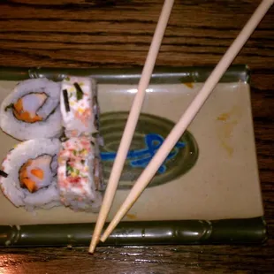 a plate of sushi and chopsticks