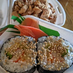 two sushi rolls on a plate