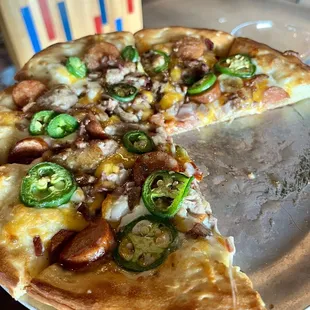 Pit master pizza with bbq on side. Was delicious. Wish we got our ranch and pepper flakes.