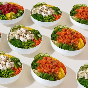 a variety of salads in white bowls