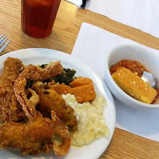 a plate of fried chicken and mashed potatoes