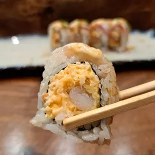 White Dragon roll - spicy crab and deep fried shrimp topped with escolar and albacore
