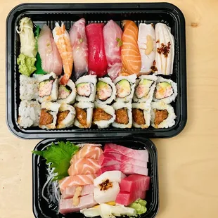 two trays of different types of sushi