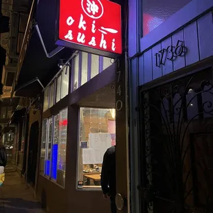 a man standing in front of a restaurant
