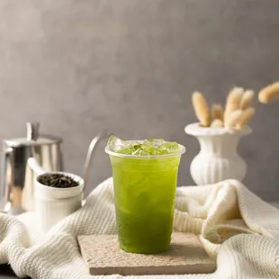 a glass of green tea on a table
