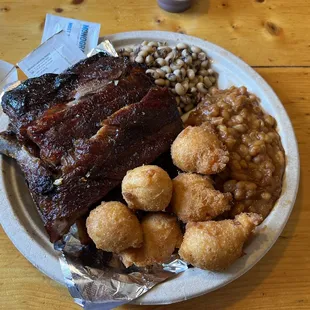 Half a rack black-eyed peas baked beans hush puppies they look good