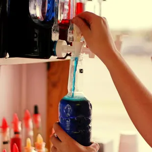 a person filling a bottle with liquid