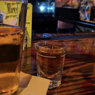 a glass of whiskey on a bar