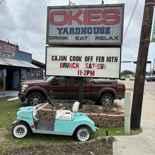 a car parked in front of a sign