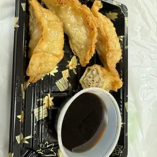 Partially eaten potsticker order--crispy, tasty &amp; good sauce
