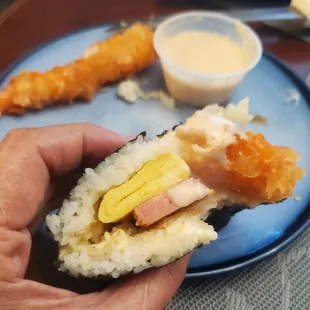 a hand holding a piece of food