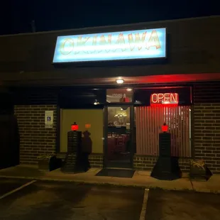 the front of the restaurant at night