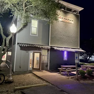 Exterior of restaurant. Stand-alone light blue building in Timbuck II shopping plaza