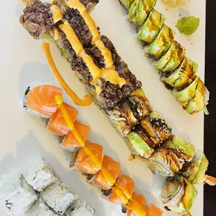 various types of sushi on a white plate