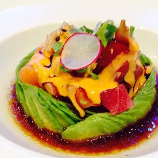 Treasures island, combinations of tuna, salmon and white fish inside avocado ring, finishing with 3 special sauces