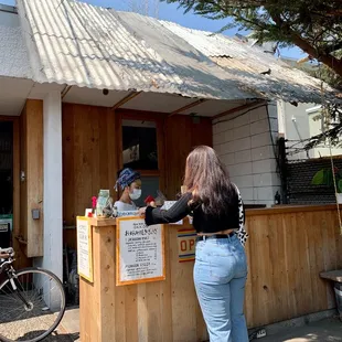 a woman standing in front of a restaurant