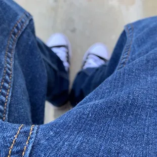 a person's feet and jeans