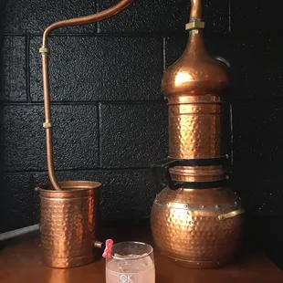 a copper pot and a glass