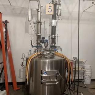 a stainless steel tank in a warehouse