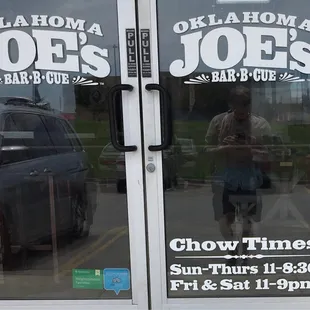 a reflection of a man in the window