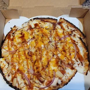 a pizza in a cardboard box