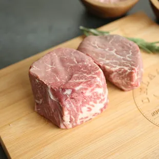 two steaks on a cutting board