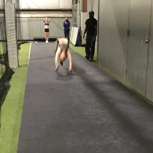 Daughter working on private tumbling lessons