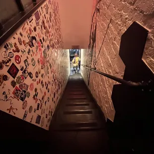 a staircase with a wall covered with stickers