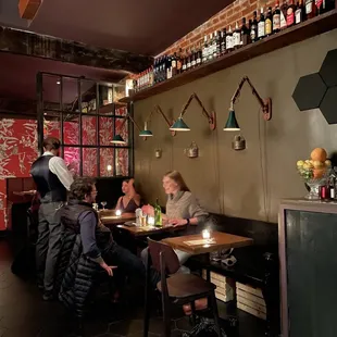 people sitting at tables in a restaurant