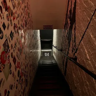 a stairway with a wall covered with stickers