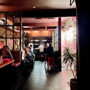 a group of people sitting at a bar