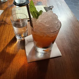 Virgin strawberry mojito and a shot glass of cucumber water