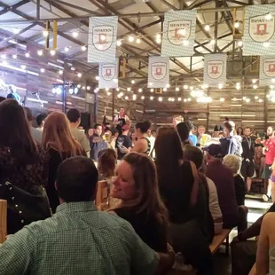 Indoor biergarten is air conditioned, and it has large community tables, a dance floor, and a stage with band performances.
