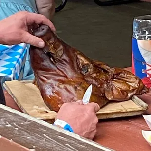 a man cutting a large piece of meat