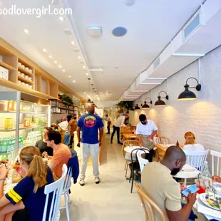 people sitting at tables in a restaurant