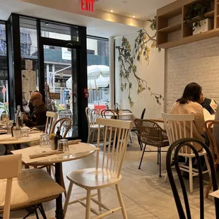 people sitting at tables in a restaurant
